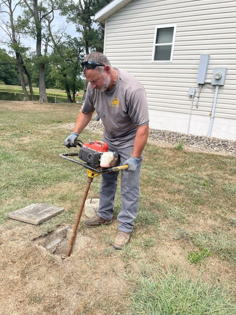 Shands Plymale, owner of All Clean Septic, agitating septic tank sludge prior to pumping.