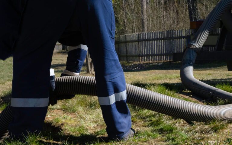 technician pumping septic tank after repair